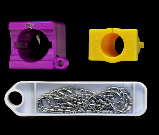 A purple and yellow plastic object next to a chain.