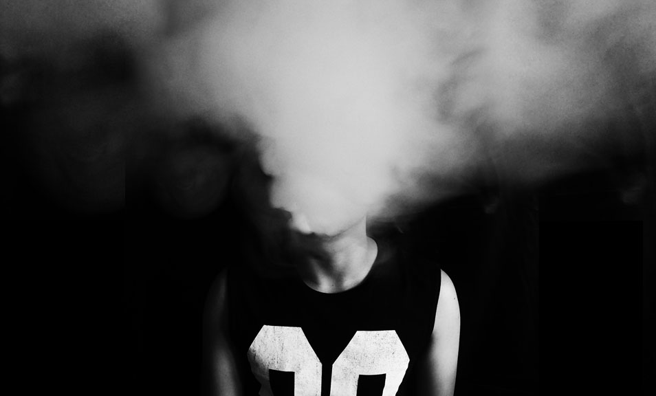 A person with smoke coming out of their mouth.